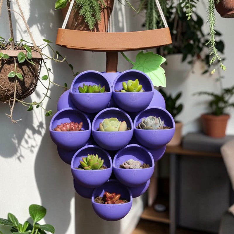 3D-printed grape pots in purple, brown, and green.