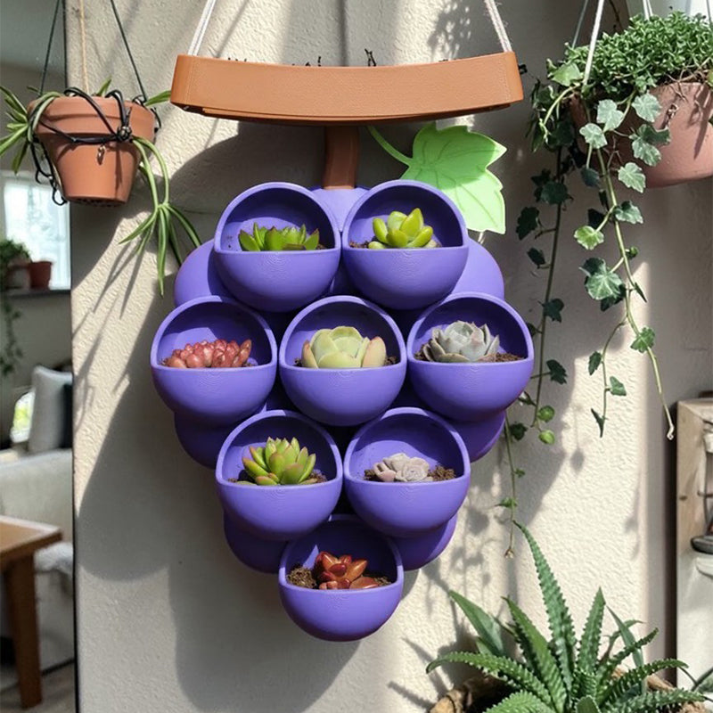 3D-printed grape pots in purple, brown, and green.
