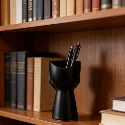 3D-printed rock face vase or office organizer, black.